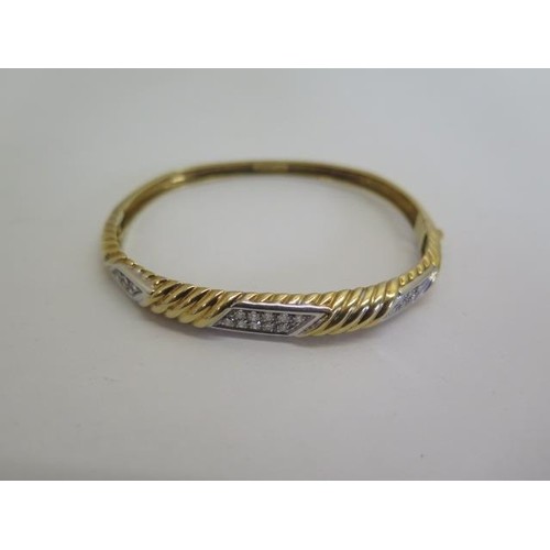 An 18ct yellow gold and white metal diamond bangle, 6.5x5.5c...