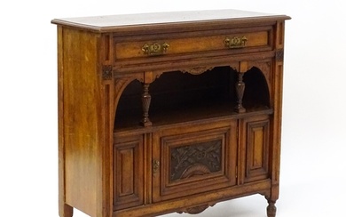 An Aesthetic movement walnut side cabinet with a chamfered f...
