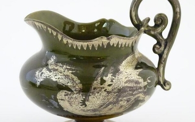 An Oriental pedestal cream jug with gilt dragon detail.