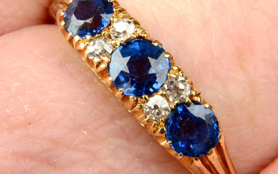 An early 20th century 18ct gold sapphire three-stone ring, with old-cut diamond double spacers.