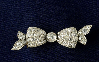 An early 20th century platinum and gold, old-cut diamond bow brooch.