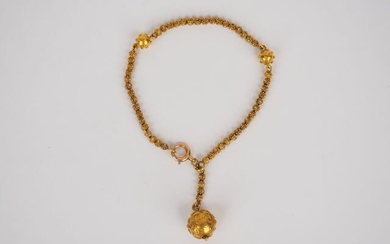 Bracelet in yellow gold, decorated with a ball-shaped pendant.