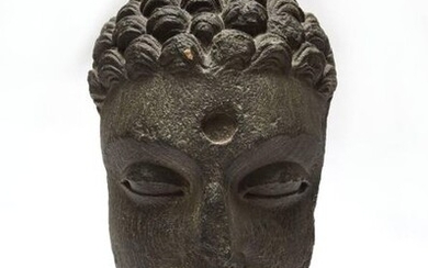 Buddha's face with its hair in fine curls,...
