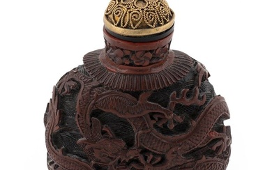 CHINESE CARVED CINNABAR SNUFF BOTTLE 20th Century Height 3". Gilt metal stopper.
