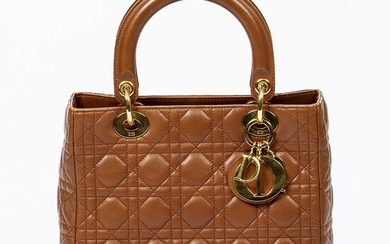 SOLD. Christian Dior: A "Lady Dior" bag made of brown cannage leather with gold tone hardware, two handles and one zipped compartment. – Bruun Rasmussen Auctioneers of Fine Art