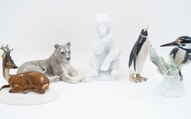 Five Continental porcelain models of animals and birds, comprising: a Berlin KPM porcelain woodpecker perching on a tree stump, first half 19th century, blue scepter and blue orb marks to the underside, 22cm high; a Meissen seated stag with turned...
