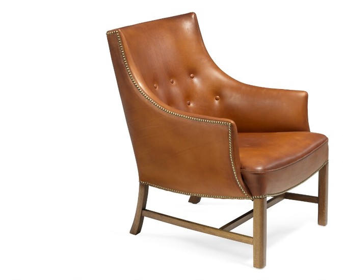 Frits Henningsen: Easy chair with mahogany frame. Upholstered with patinated brown leather, fitted with brass nails, back fitted with buttons.