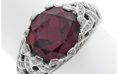Garnet, Diamond, Platinum Ring Stones: Oval-shaped rhodolite garnet weighing...