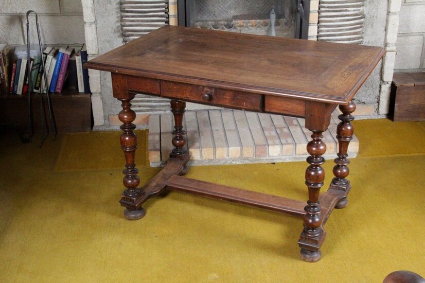 Louis XIII style writing table in walnut. It rests on baluster-turned uprights, joined by an H-shaped spacer, finished with flattened boulle legs. 19th century. H : 72 x W : 102 x D : 65 cm
