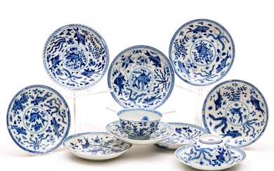 Nine blue and white fish saucers with two cups