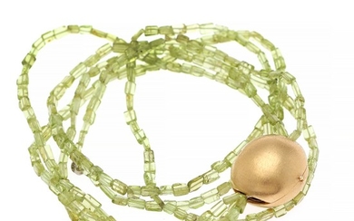 Ole Lynggaard: A large oval ball clasp of 14k satin finish gold set on a three strand peridot necklace. L. 2.3 and 41 cm. (2)