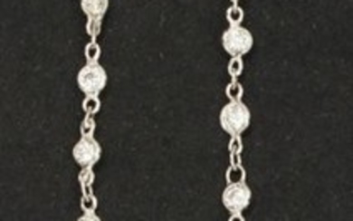 Pair of white gold earrings with poly-lobed motifs...