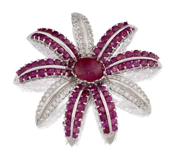 Ruby and diamond flower clip brooch, designed as a central single cabochon ruby, to circular-cut ruby double row petals, three petals being set with brilliant-cut diamonds, stamped 750, approx. width 4.5cm