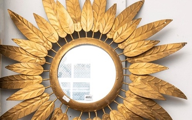 A CIRCULAR WALL MIRROR WITH GILDED OUTER LEAF DECORATION