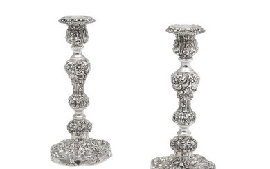 A pair of English silver Rococo candlesticks