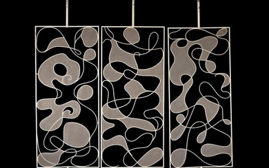 A three-section painted metal screen or room divider