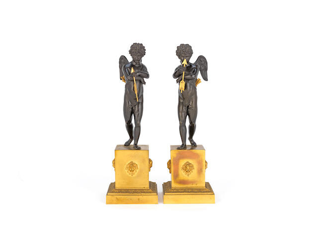 A pair of early 19th century French gilt and patinated bronze figures of Cupid