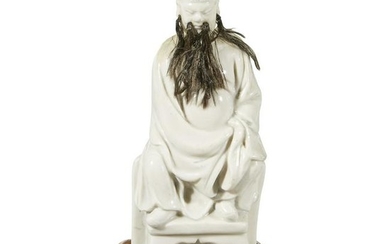 A Chinese blanc de Chine figure of seated Guandi