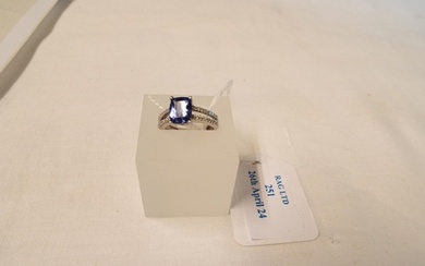 A 18ct white gold ring inset with large tanzanite flanked by...
