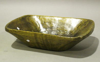 A 19th century primitive walnut rectangular bowl with pierced handle, width 56cm.
