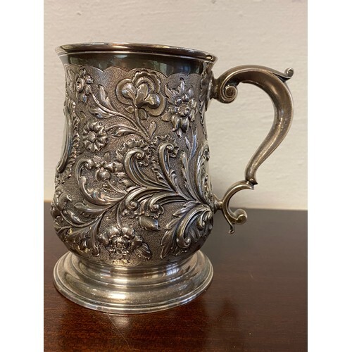 A 19th century tankard, 1831, of baluster form and repousse ...