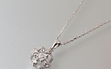 A 750 thousandth white gold openwork pendant and chain, the openwork pendant is centered on a modern cut diamond hemmed with a scalloped line set with diamonds.