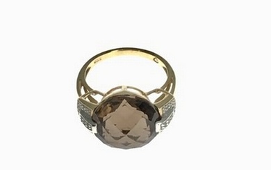 A 9ct gold smoky quartz ring, diamond set shoulders