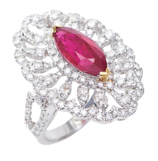 A BURMESE RUBY AND DIAMOND DRESS RING-Featuring a marquise cut ruby weighing 3.29cts, within a decorative pierced surround of round...