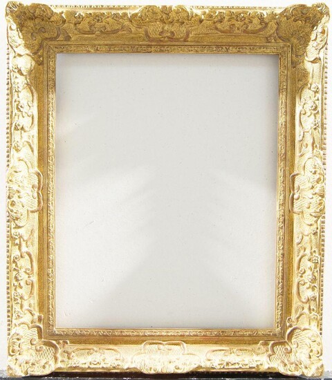 A Belgian Gilded Composition Louis XIV Style Frame, early 20th century, with leaf sight, the cross-hatched ogee with foliate and flower head strapwork shell cartouche centres and corners, bears applied label for Ach van Loo, Encandrements d'Art...