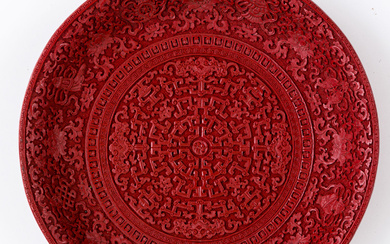 A CHINESE WOOD-CARVED CINNABAR LACQUER DISH