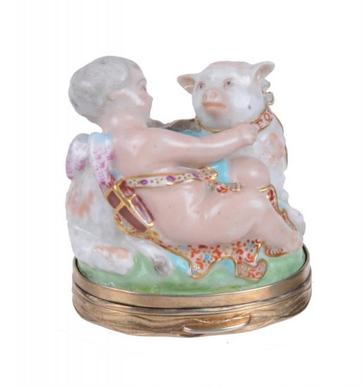 A Charles Gouyn St. James's factory type gilt-metal-mounted bonbonière and hinged moss-agate cover modelled as Cupid with a lamb