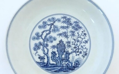 A Chinese blue and white dish with blossoming trees and