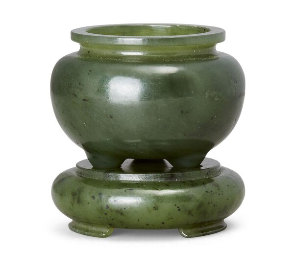 A Chinese spinach-green jade miniature tripod censer and stand, Republic period, of typical bulbous form with three rounded feet, the stone of dark green tone sparsely included with black specks 5.5cm high