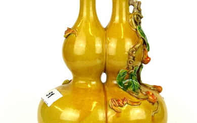 A Chinese yellow glazed porcelain double gourd vase, H. 21cm.