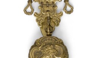 A George III gilt-brass etui with chatelaine, late 18th century, the scroll clip hung with two vacant loops and an ogee sided necessaire worked in high relief with classical maidens and putto amid scrolls, the fitted incomplete interior with pen...