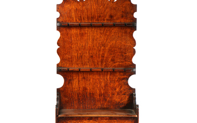 A George III oak and mahogany inlaid spoon rack, Lancashire, circa 1800 Having a tall one-piece