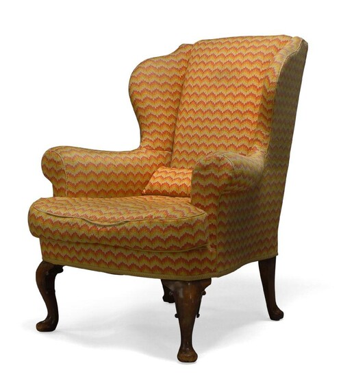 A George III style wingback armchair, first half 20th Century,...