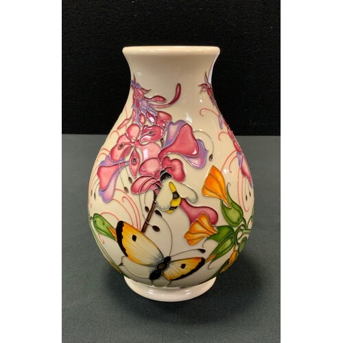 A Moorcroft pottery baluster vase decorated in the Family T...