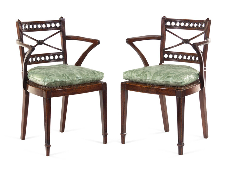 A Pair of Regency Carved Mahogany Cane Upholstered Armchairs
