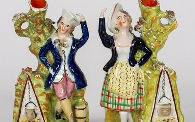 A Pair of Staffordshire Male and Female Figural Spill