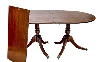 A Regency style brass inlaid mahogany D-end dining table. Th...