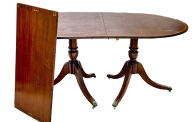 A Regency style brass inlaid mahogany D-end dining table.