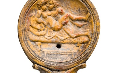 A Roman oil lamp with erotic scene, 1st century