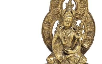 NOT SOLD. A Tibetan gilt copper repoussé figure of Padmasambhava. 17th-18th century. Weight 1070 g. H. incl. mandorla 23 cm. – Bruun Rasmussen Auctioneers of Fine Art