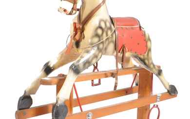 An early 20th century circa 1920s wooden child's rocking horse in the manner of G&K Lines / Leeway. The horse with red leatherette detailing. The horse in white & black colourways, red saddle & raised on an articulate trestle base. Measures approx.