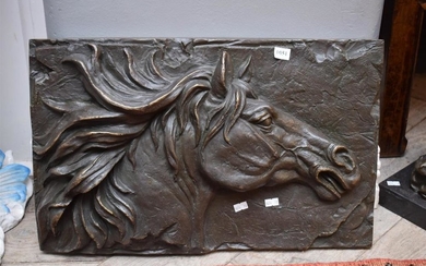 A WALL HANGING BRONZE OF A HORSE