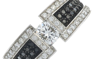 A brilliant-cut diamond and black gem dress ring.