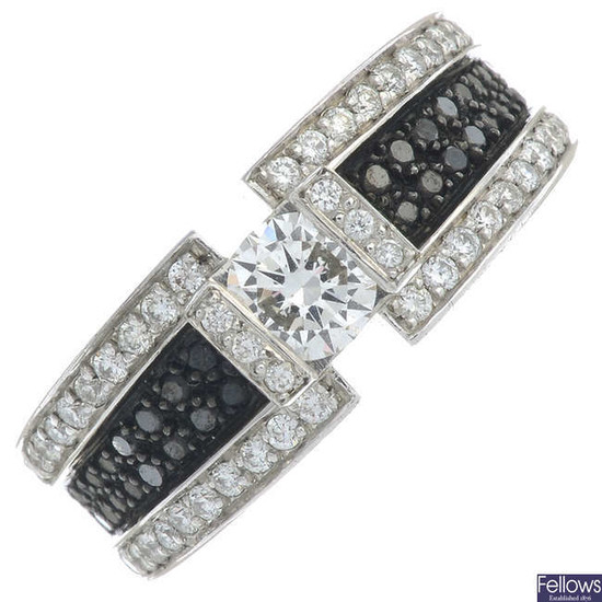 A brilliant-cut diamond and black gem dress ring.