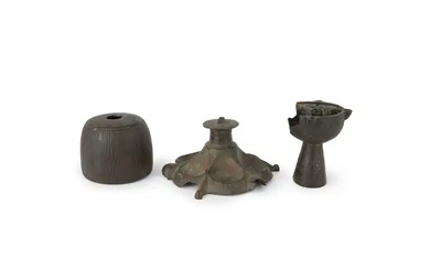 A bronze lampstand base, a bronze inkwell and a silver-inlaid oil lamp,...