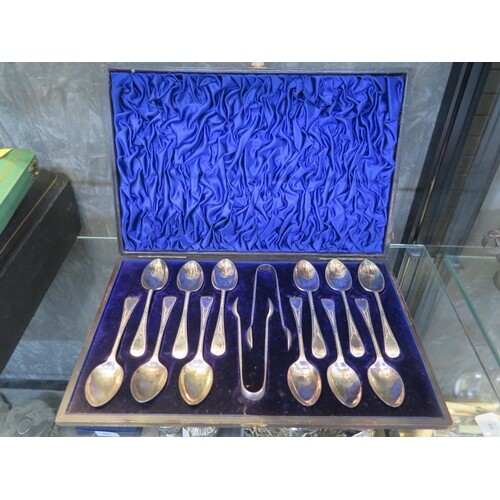 A cased set of twelve silver spoons with two pairs of silver...